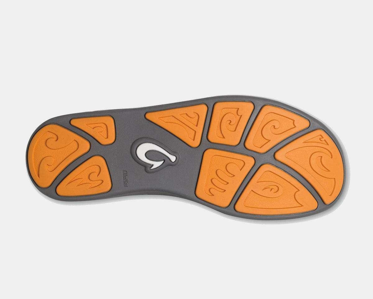OluKai Nohea Mesh shoes outsole view with orange rubber inserts featuring wave-patterned designs and gray base for traction.
