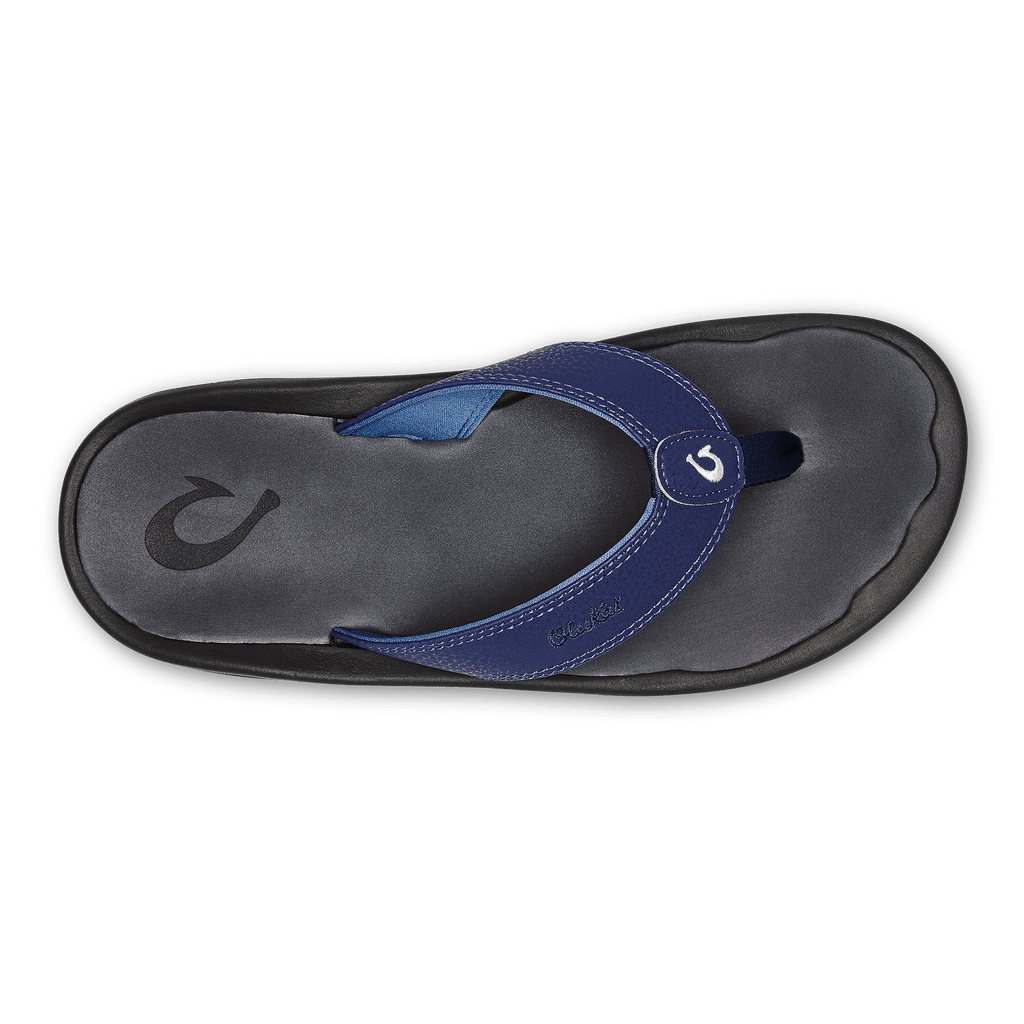 OluKai Ohana flip-flops top view featuring blue synthetic leather straps, embroidered logo, and cushioned gray footbed with black outsole.