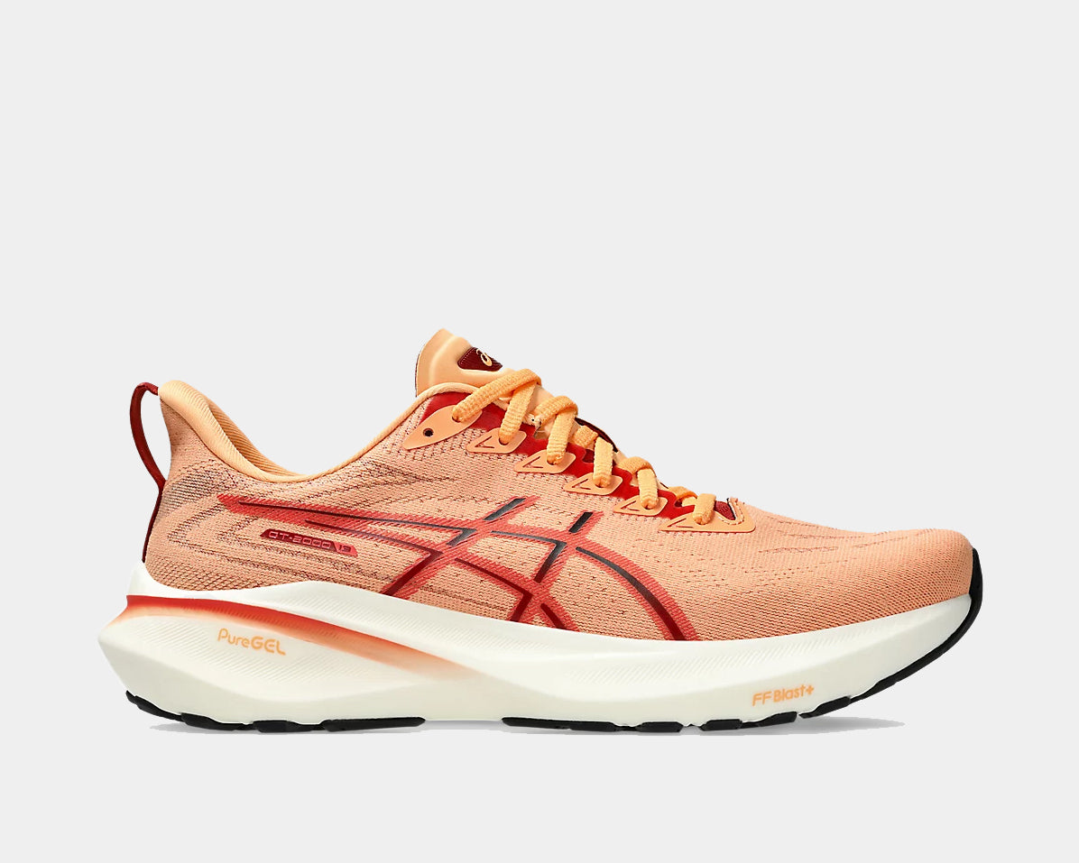 A pair of light orange ASICS GT-2000 13 running shoes with white and gray accents.