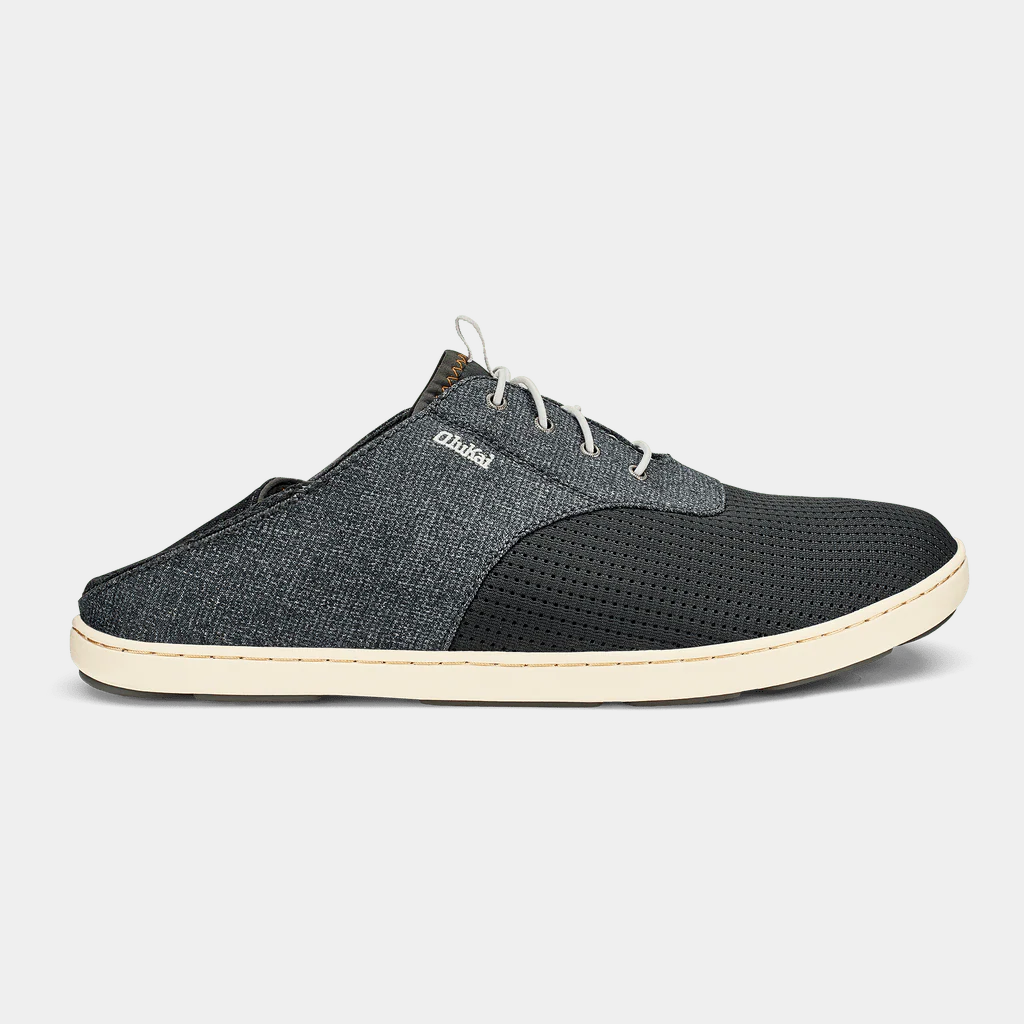 OluKai Nohea Moku shoes in dark gray with a breathable mesh upper, foldable heel, and white sole, side view.