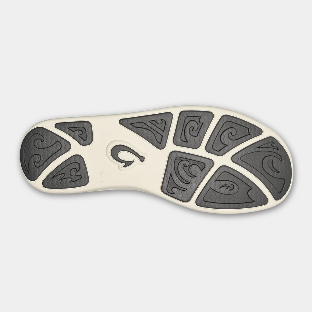 OluKai Nohea Moku shoes outsole with wave-patterned rubber tread in black and beige, bottom view