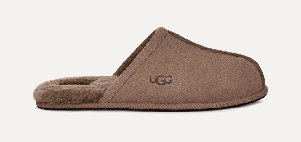 A light brown UGG Scuff slipper with a suede upper and sheepskin lining, featuring the UGG logo embossed on the outsole.
