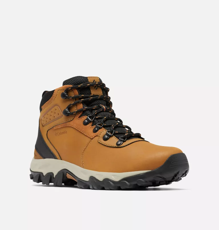 Columbia Newton Ridge Plus II Waterproof hiking boots in tan leather with black accents, mesh collar, metal eyelets, and rugged outsole, front side angle.