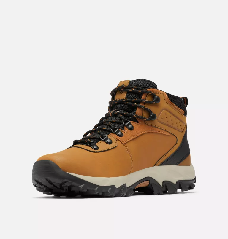 Columbia Newton Ridge Plus II Waterproof hiking boots in tan with black accents, durable leather upper, and rugged outsole, angled front view.
