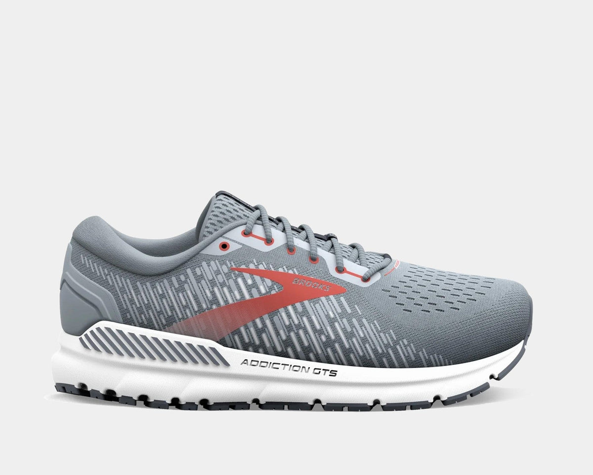 Brooks Addiction GTS 15 running shoes in gray with red accents, featuring GuideRails support system, side view.