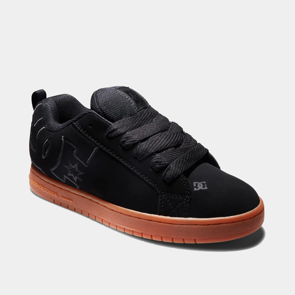 DC Footwear Court Graffik sneakers in black with oversized logo details and gum rubber sole, angled side view.