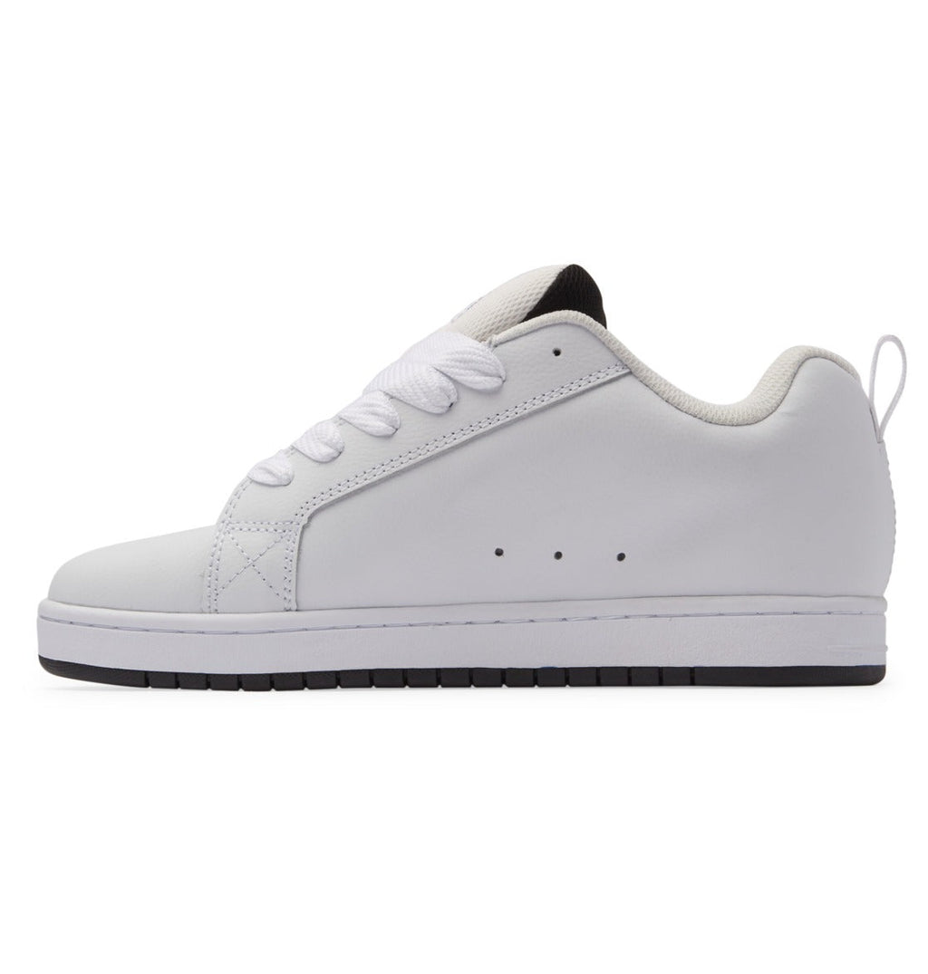 DC Footwear Court Graffik sneakers side view, white leather upper with perforation details, padded collar, and black outsole.