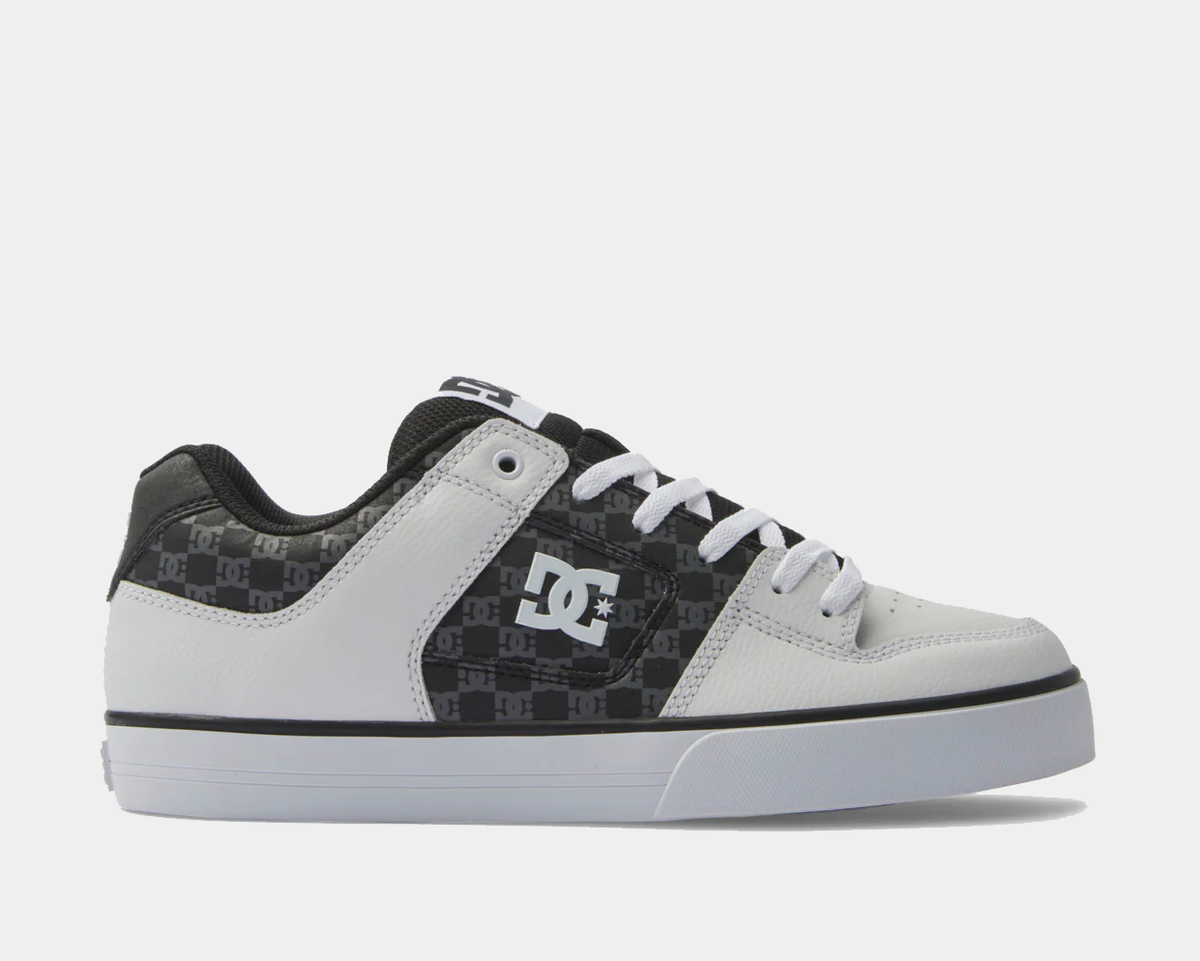 DC Footwear Pure sneakers in white and black with textured leather upper and signature DC logo on the side, side view.