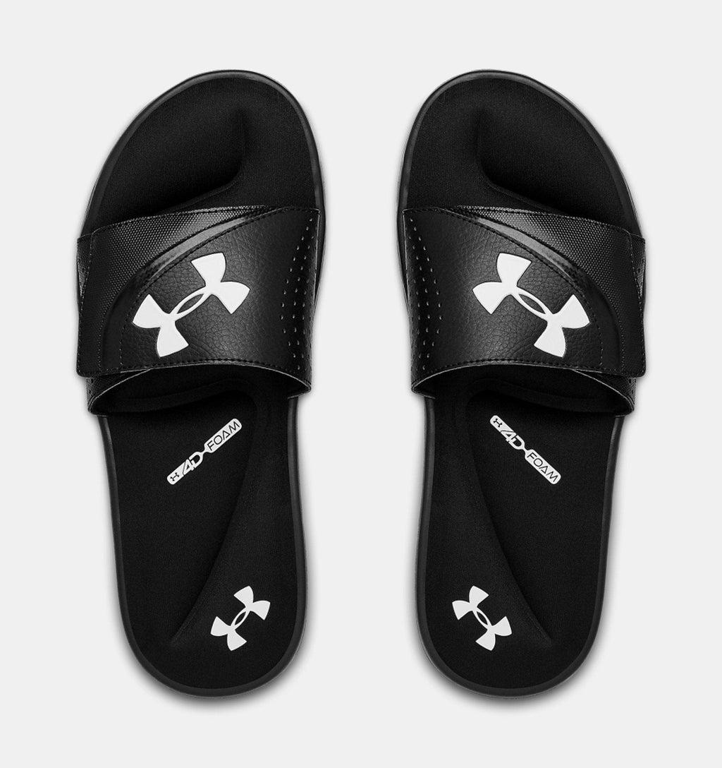 Under Armour Ignite VI SL sandals in black with white logo on strap and footbed, featuring cushioned foam sole, top view.