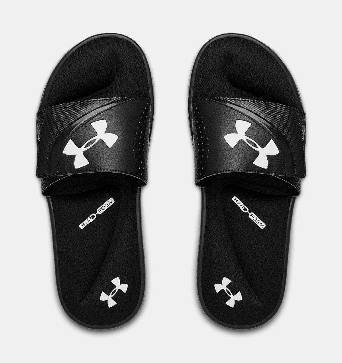 Under Armour Ignite VI SL sandals in black with white logo on strap and footbed, featuring cushioned foam sole, top view.