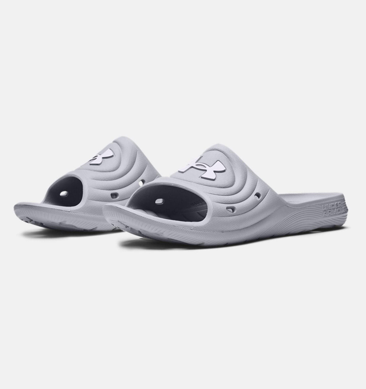 Under Armour Locker IV SL slides in light gray with textured synthetic upper, open-toe design, and durable outsole, angled front view.