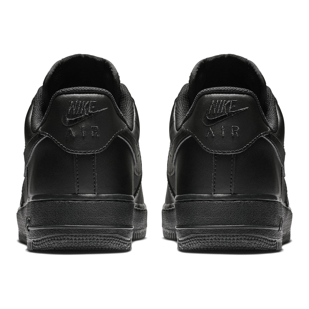 Nike Air Force 1 '07 sneakers in black, back view showing embossed Nike Air branding and textured heel design.