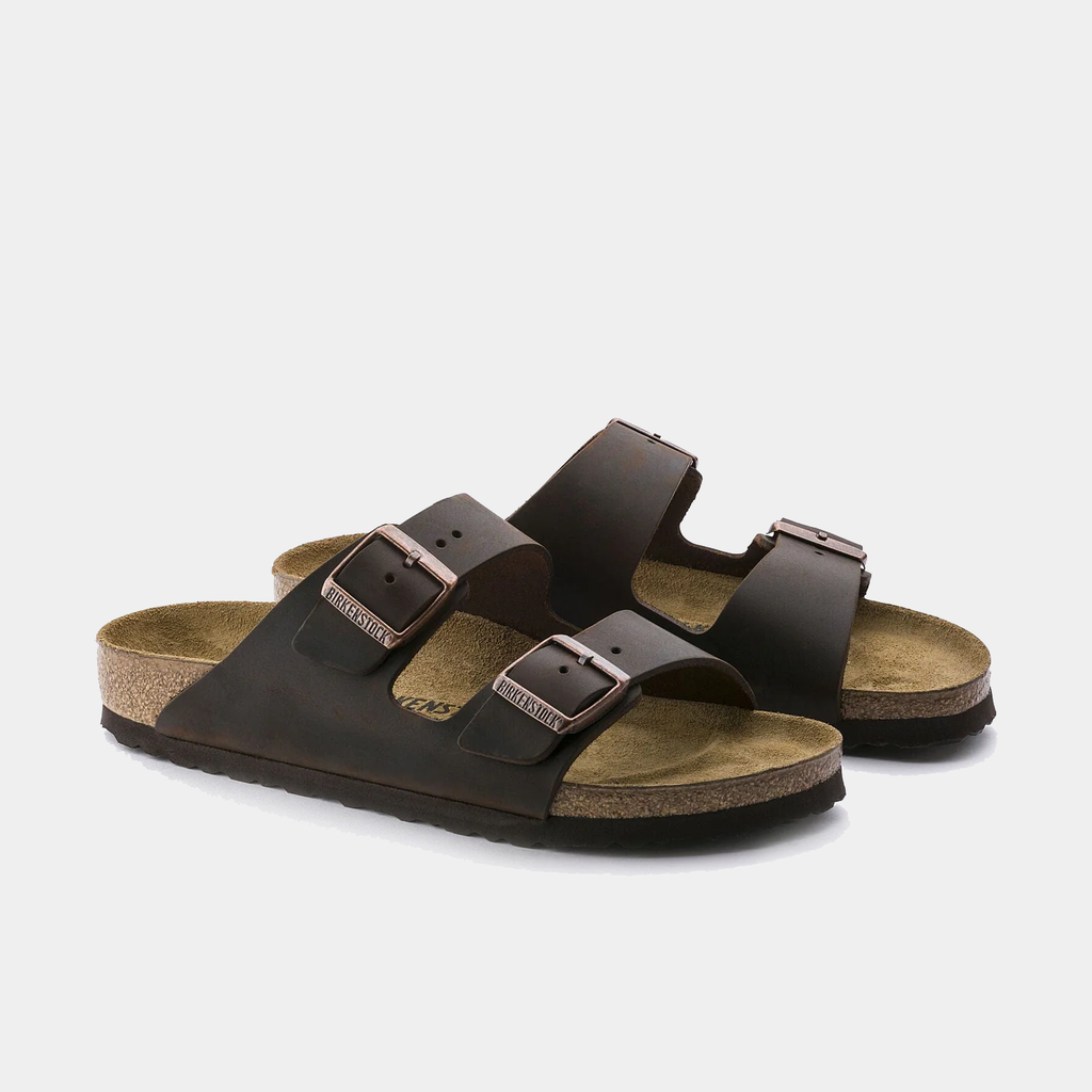Birkenstock Arizona Oiled Leather sandals in dark brown with adjustable buckles and cork footbed, front angle view.