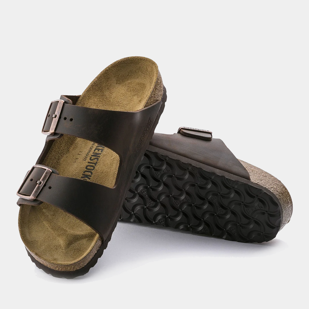 Birkenstock Arizona Oiled Leather sandals with dark brown leather straps, adjustable buckles, cork footbed, and black textured outsole.