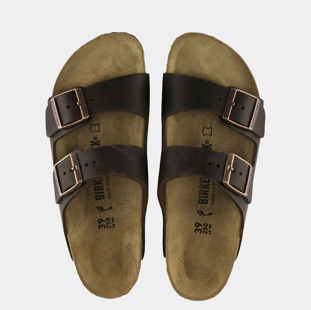 Birkenstock Arizona Oiled Leather sandals with dark brown leather straps, adjustable metal buckles, and contoured cork footbed, top view.