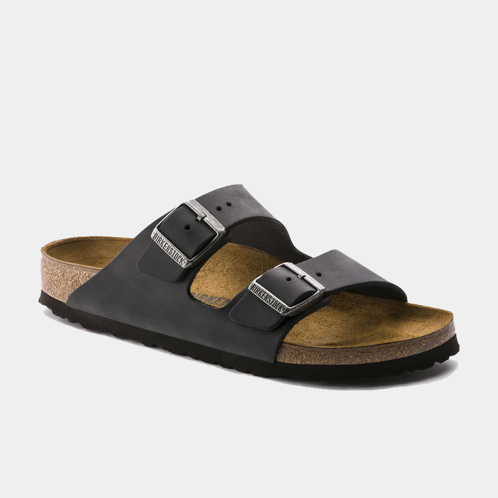 Birkenstock Arizona Oiled Leather sandals in black with adjustable buckle straps and cork footbed, side angle view.