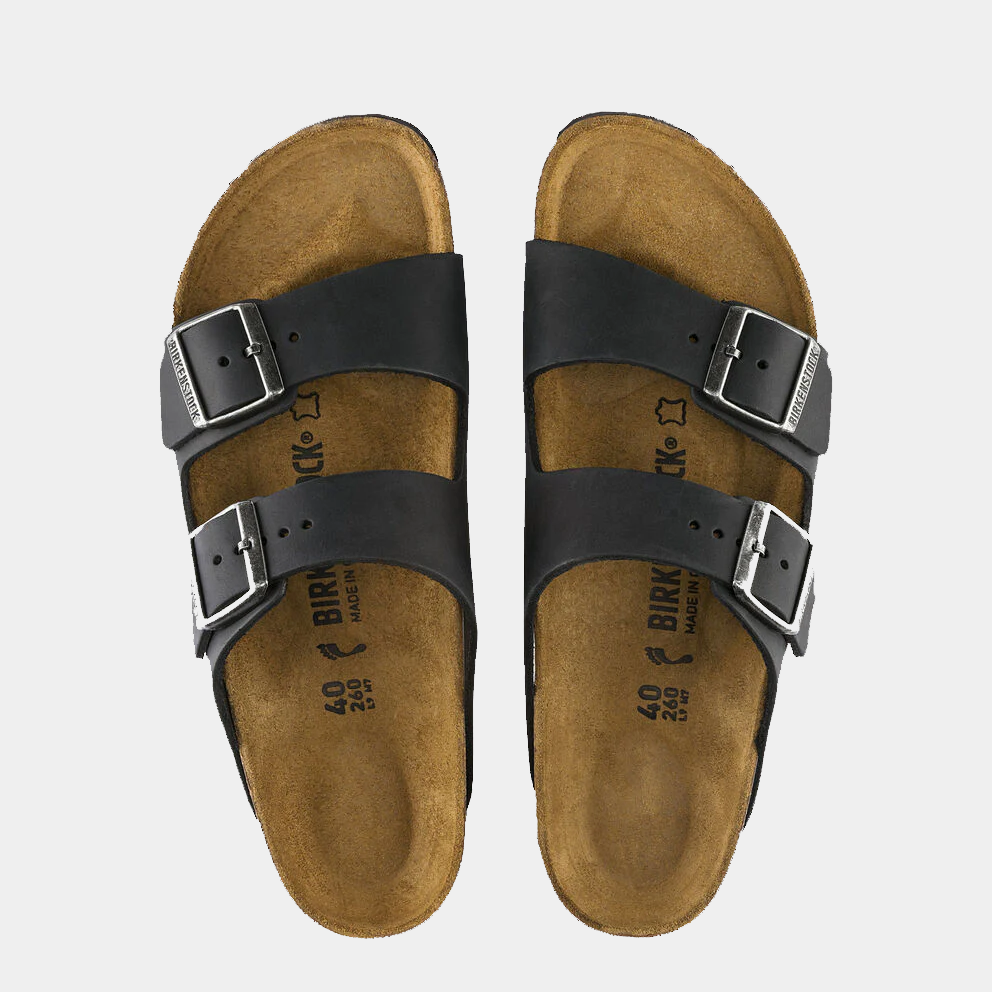 Birkenstock Arizona Oiled Leather sandals in black with adjustable buckled straps and contoured cork footbed, top view.