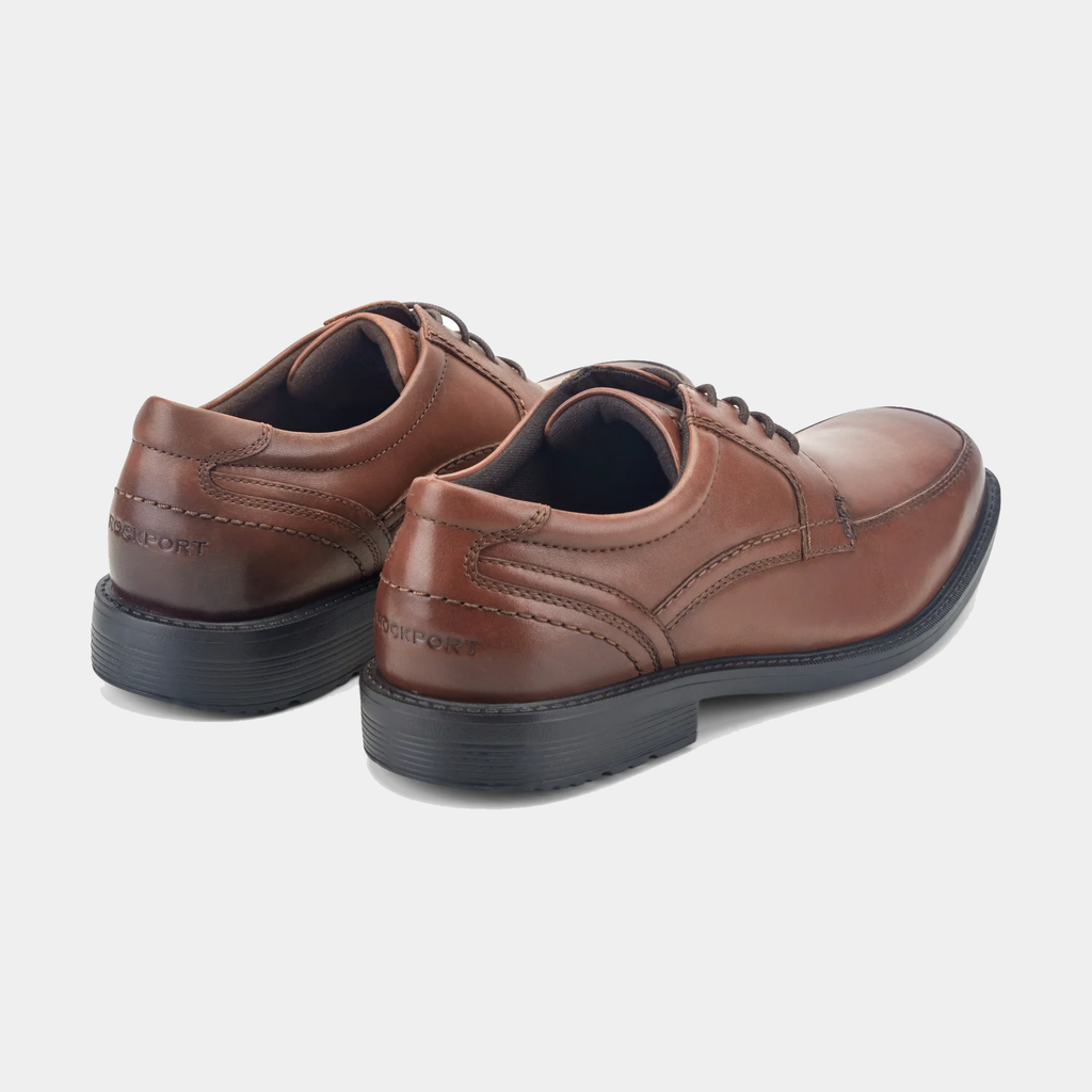 Rockport Style Leader 2 Apron Toe dress shoes in brown leather with stitching details and cushioned black soles, back angle view.