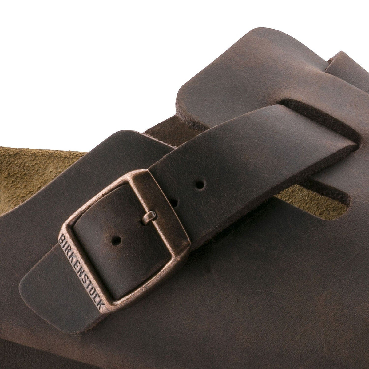 Birkenstock Boston Oiled Leather clogs in dark brown with adjustable buckle detail and suede lining, close-up view.