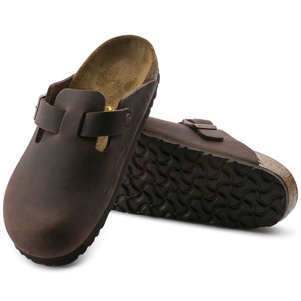 Birkenstock Boston Oiled Leather clogs in dark brown with adjustable strap and cork footbed, angled view showing outsole.