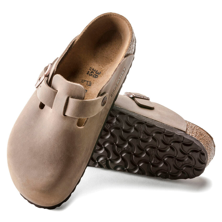 Birkenstock Boston Oiled Leather clogs in light brown with adjustable strap and cork footbed, sole and top view displaying details.