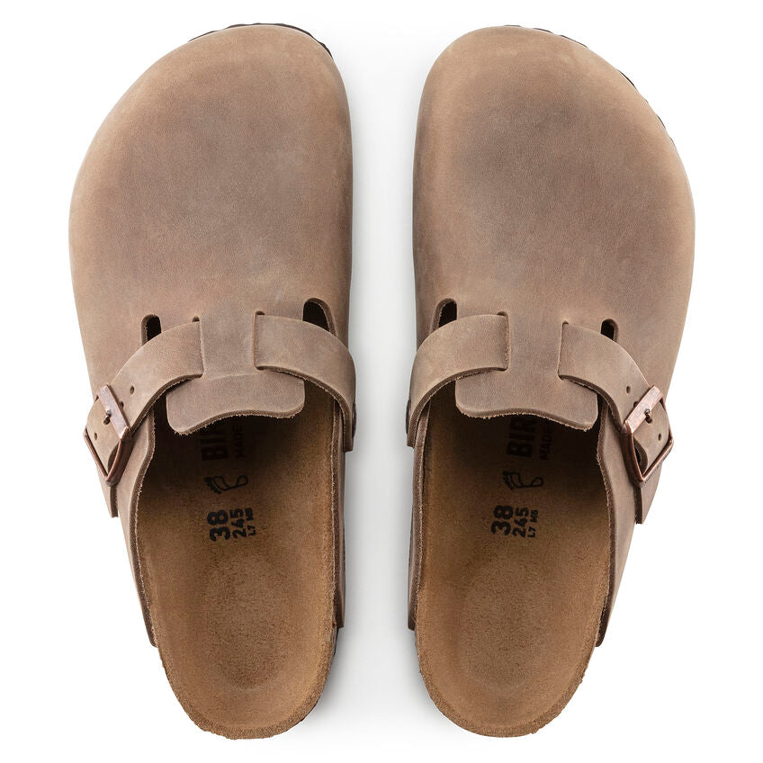 Birkenstock Boston Oiled Leather clogs in brown with adjustable strap and closed-toe design, top view showing smooth leather finish.