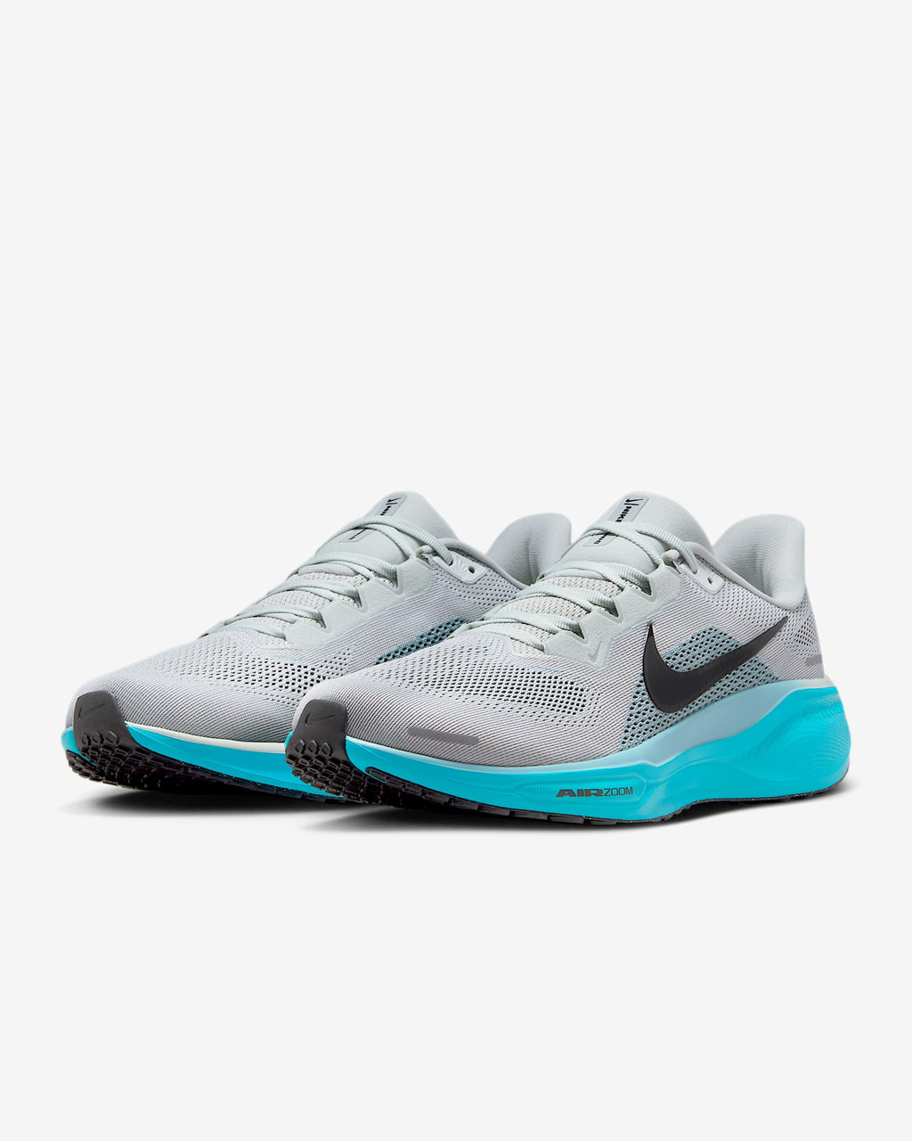 A pair of white Nike Air Zoom Pegasus 41 running shoes with black and blue accents and a black and white sole.