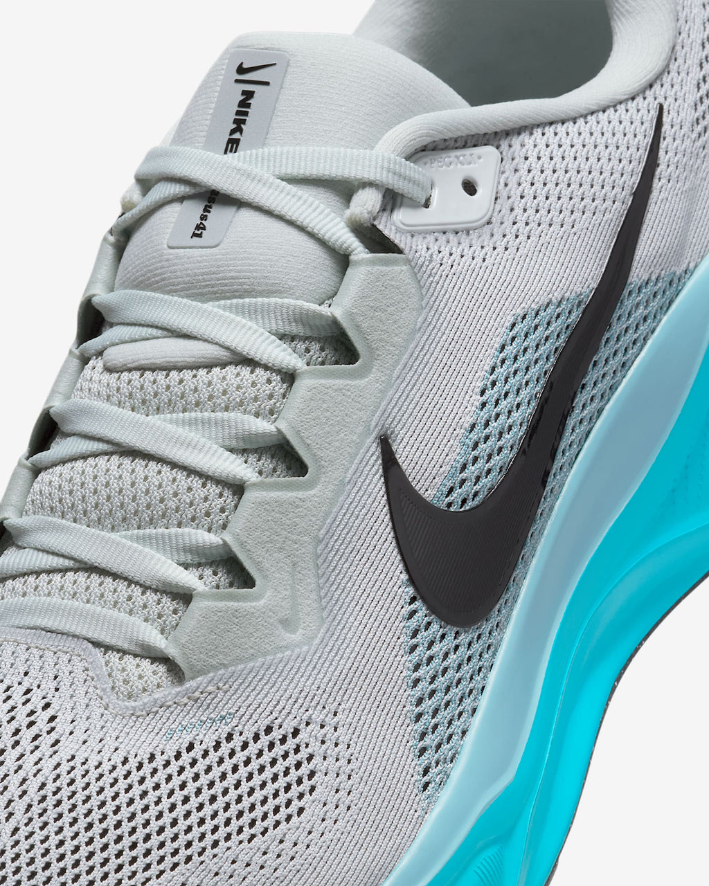 A pair of white Nike Air Zoom Pegasus 41 running shoes with black and blue accents and a black and white sole.