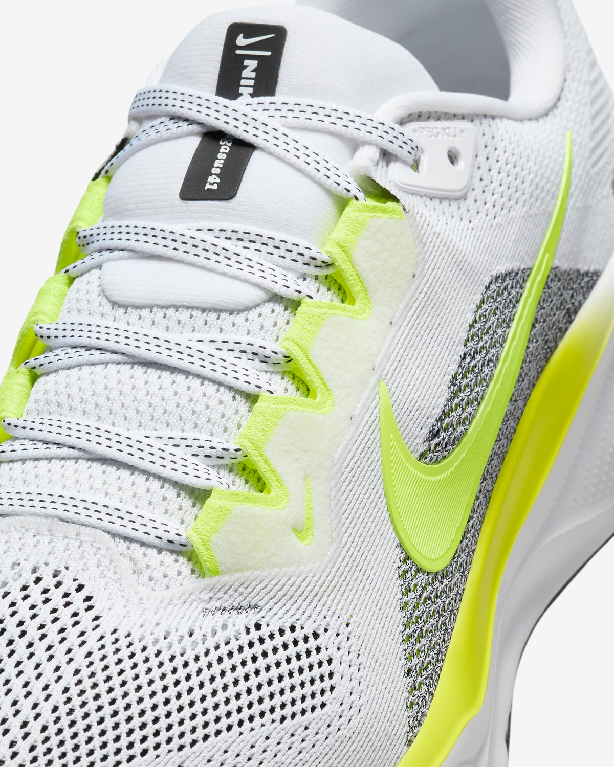 A pair of white Nike Air Zoom Pegasus 41 running shoes with yellow and grey  accents and a white and black sole.