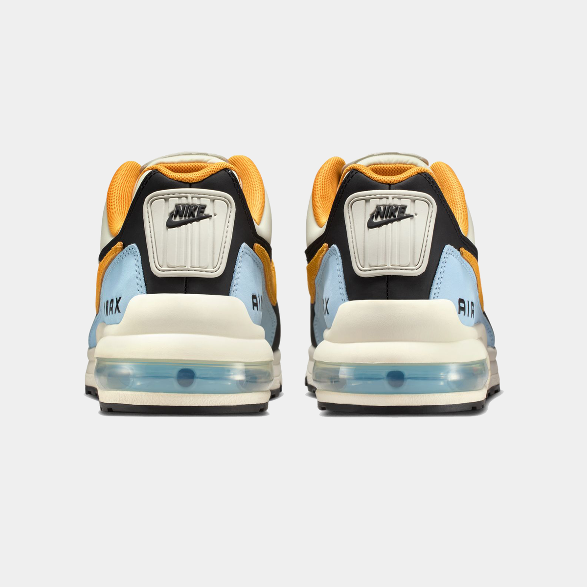 Pair of Nike sneakers showing the sole and brand logo on a white background