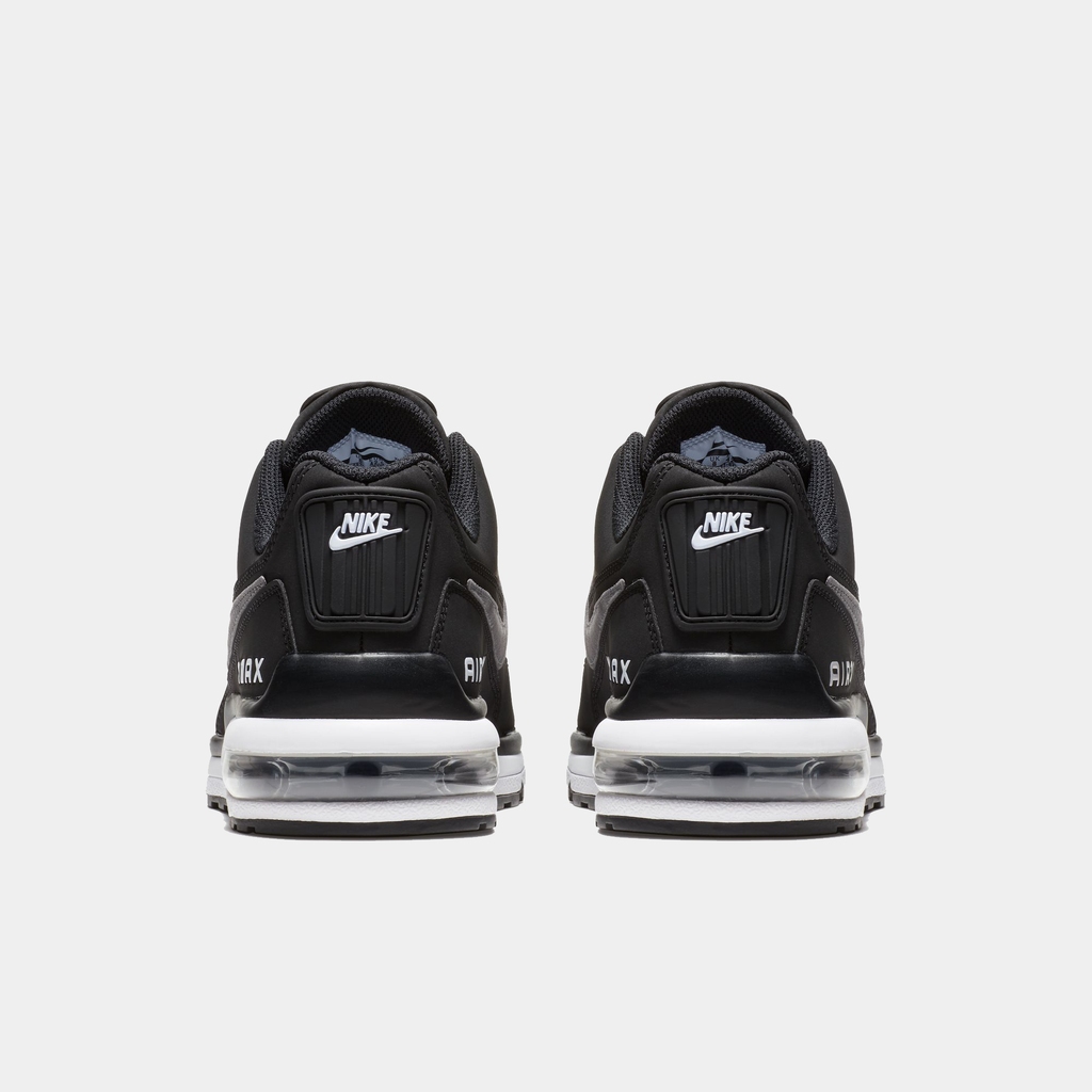Black Nike sneakers with clear air cushion sole on a white background