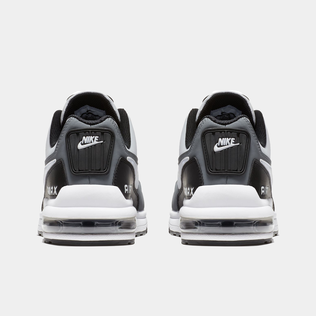 Black and white Nike sneakers with visible brand logo on a white background