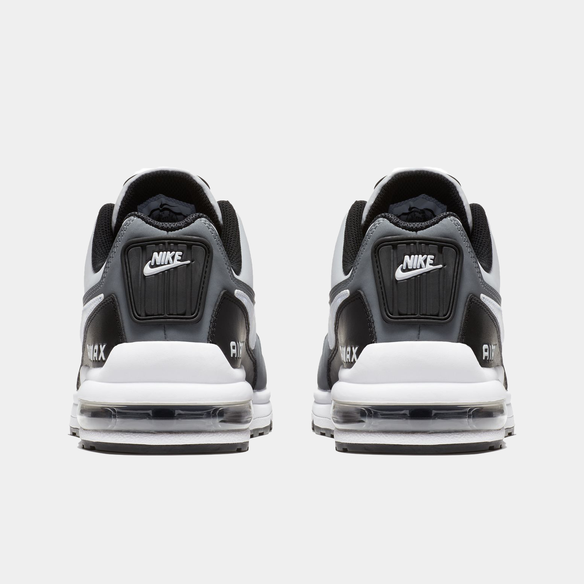 Black and white Nike sneakers with visible brand logo on a white background