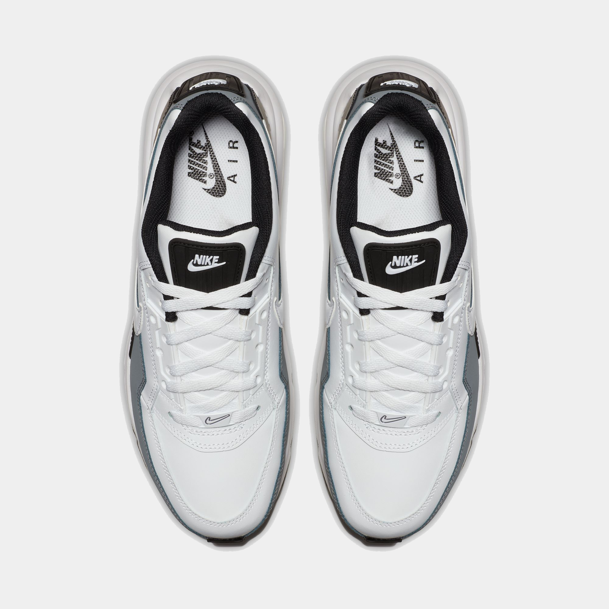 White Nike Air sneakers with black swoosh logo on a white background