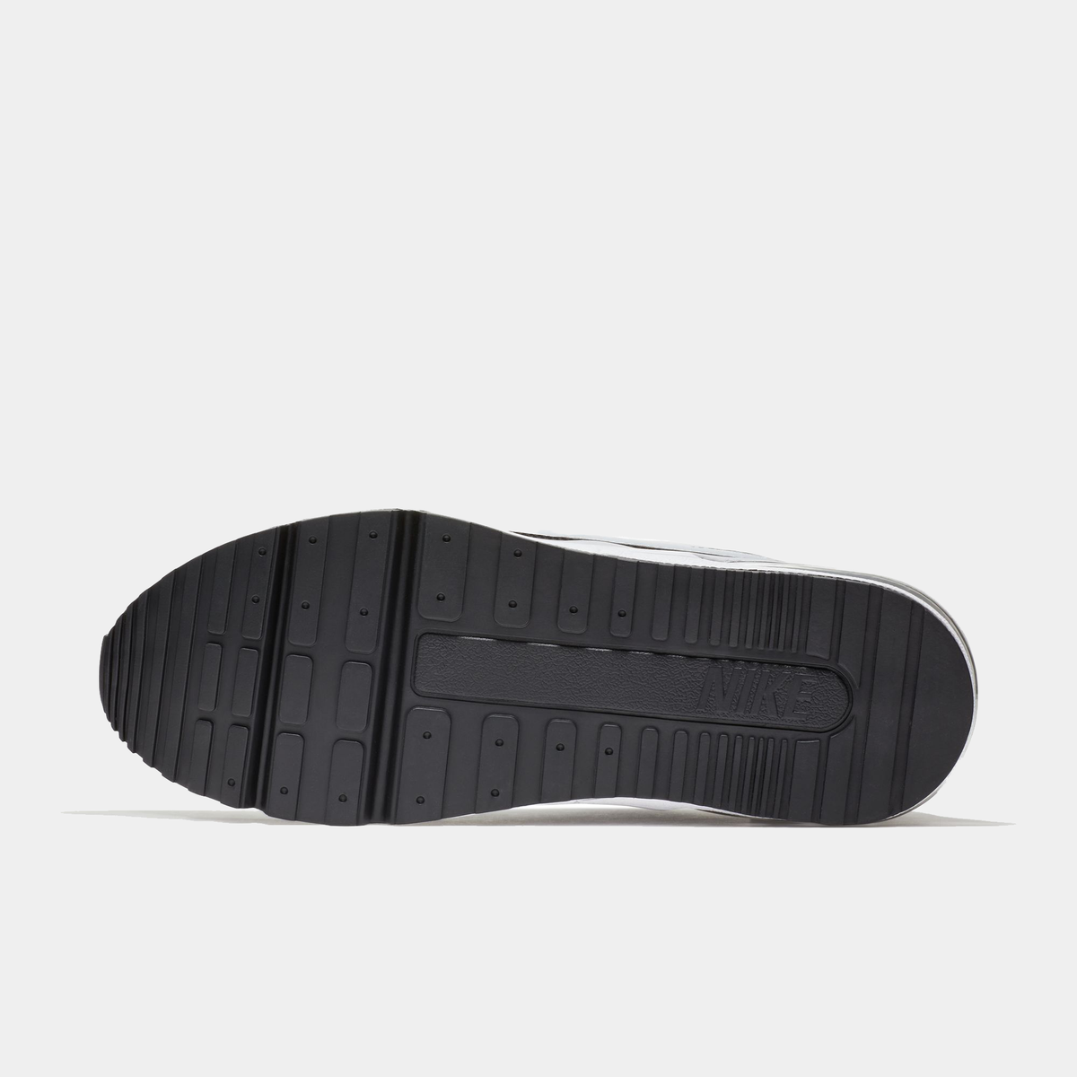 Black sole of a sneaker on a light gray background