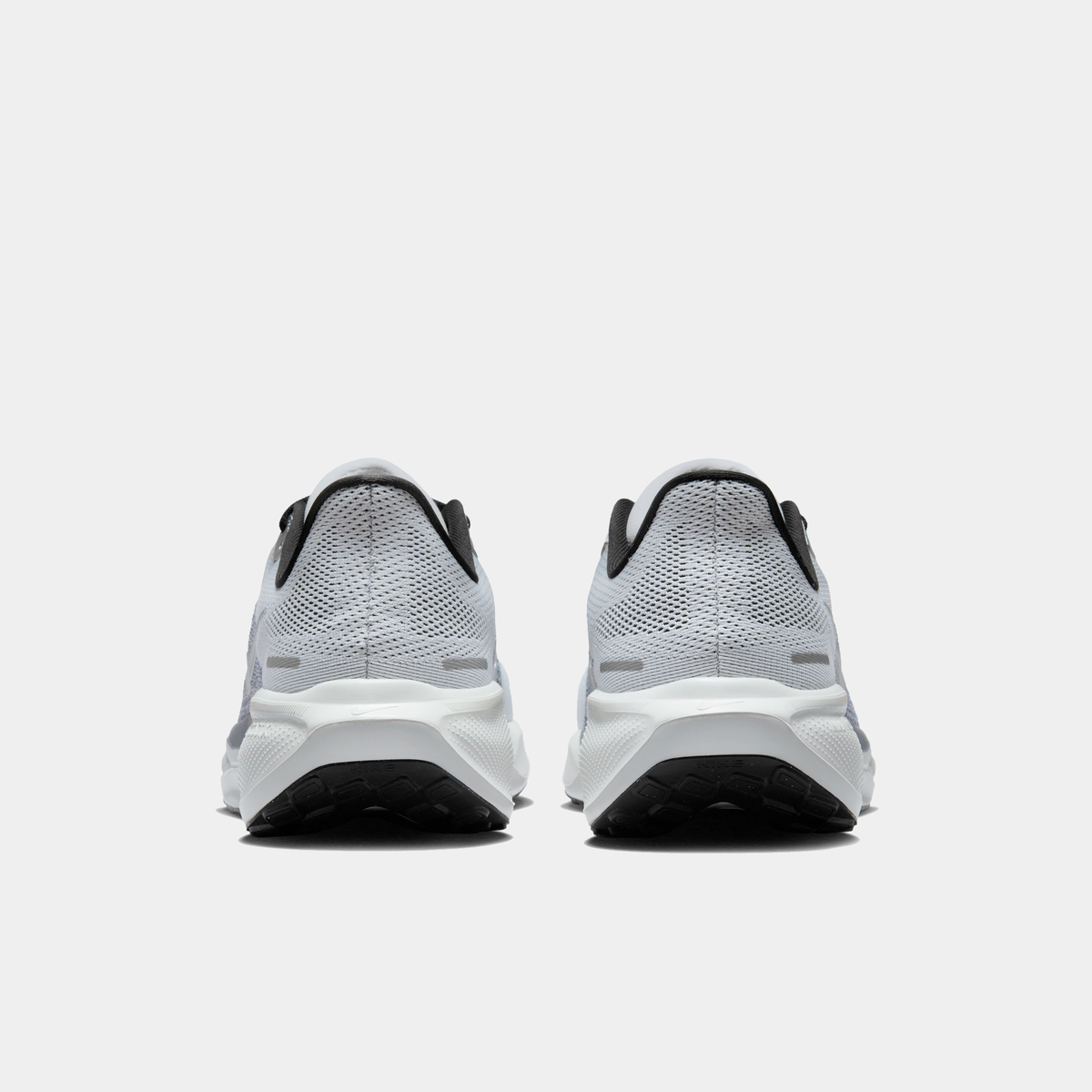 A pair of white and black Nike Air Zoom Pegasus 41 running shoes with a white and black sole.