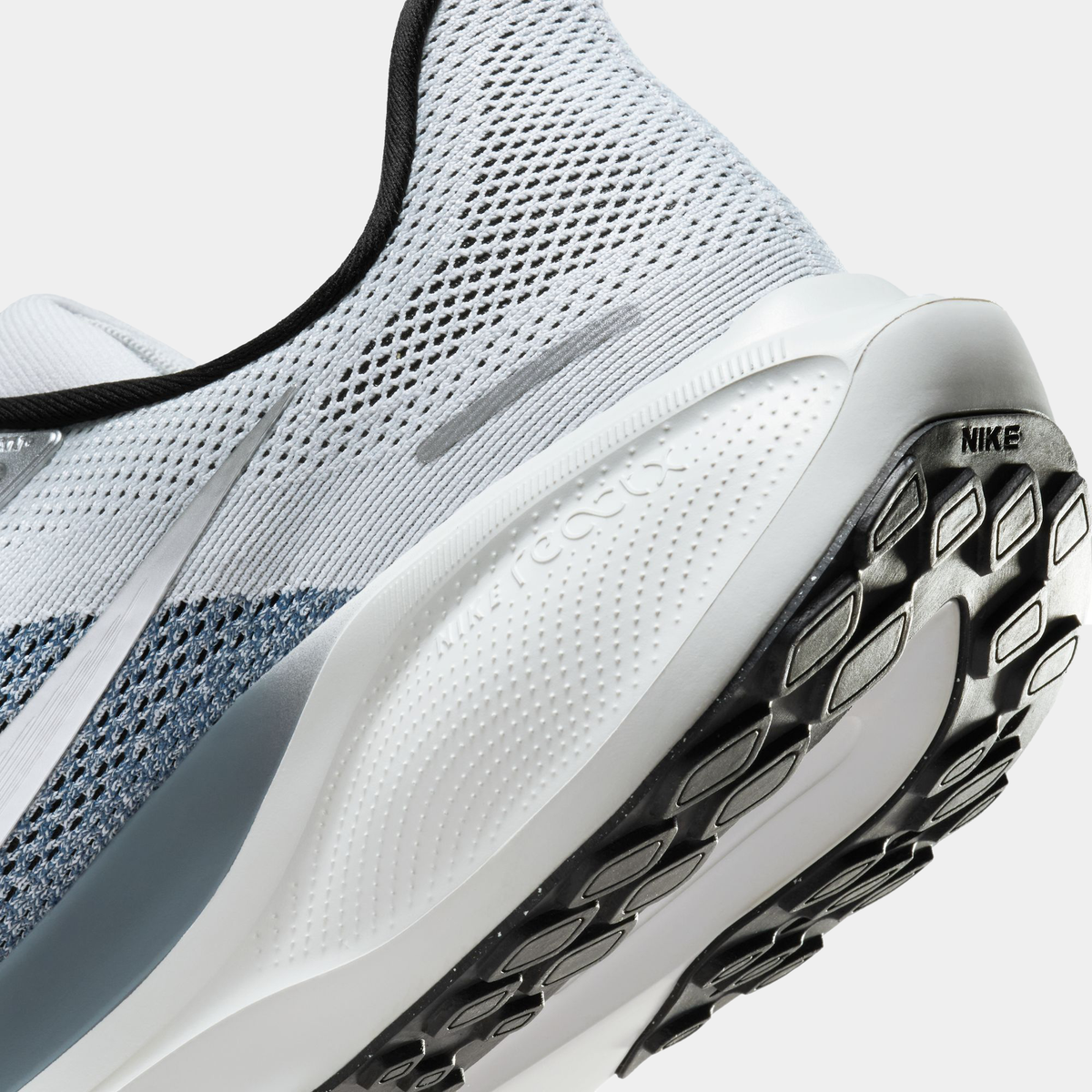 A pair of white and black Nike Air Zoom Pegasus 41 running shoes with a white and black sole.