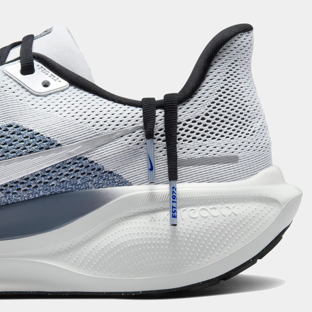 A pair of white and black Nike Air Zoom Pegasus 41 running shoes with a white and black sole.