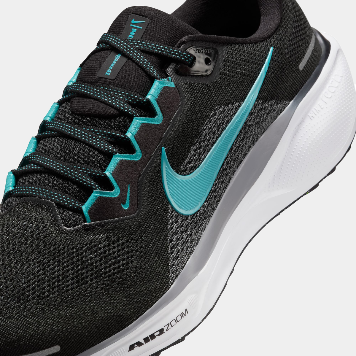 A pair of black Nike Air Zoom Pegasus 41 running shoes with turquoise accents and a black and white sole.