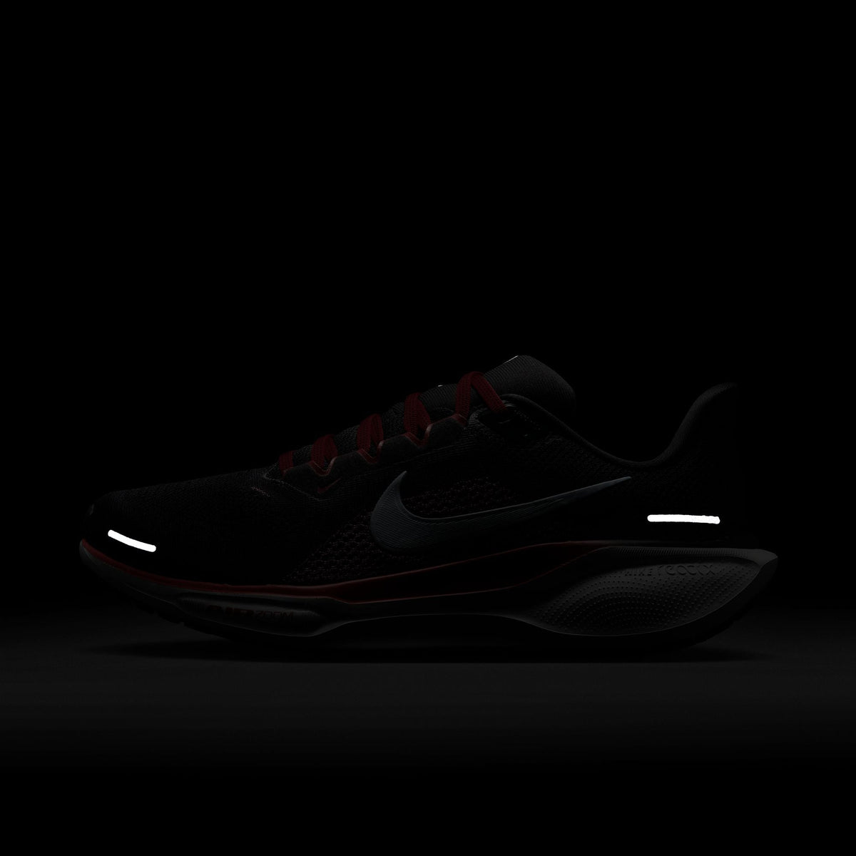 A pair of black Nike Air Zoom Pegasus 41 running shoes with white and red accents and a black and white sole.