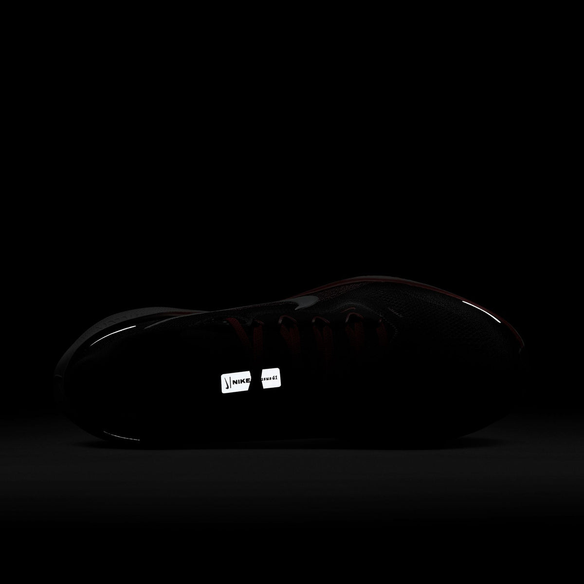 A pair of black Nike Air Zoom Pegasus 41 running shoes with white and red accents and a black and white sole.