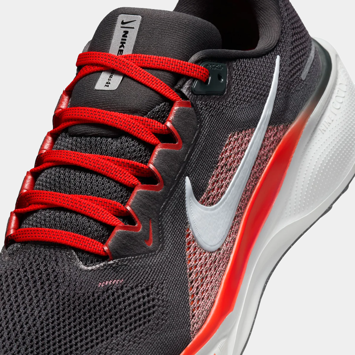A pair of black Nike Air Zoom Pegasus 41 running shoes with white and red accents and a black and white sole.