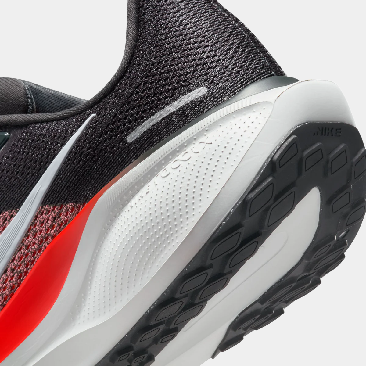 A pair of black Nike Air Zoom Pegasus 41 running shoes with white and red accents and a black and white sole.
