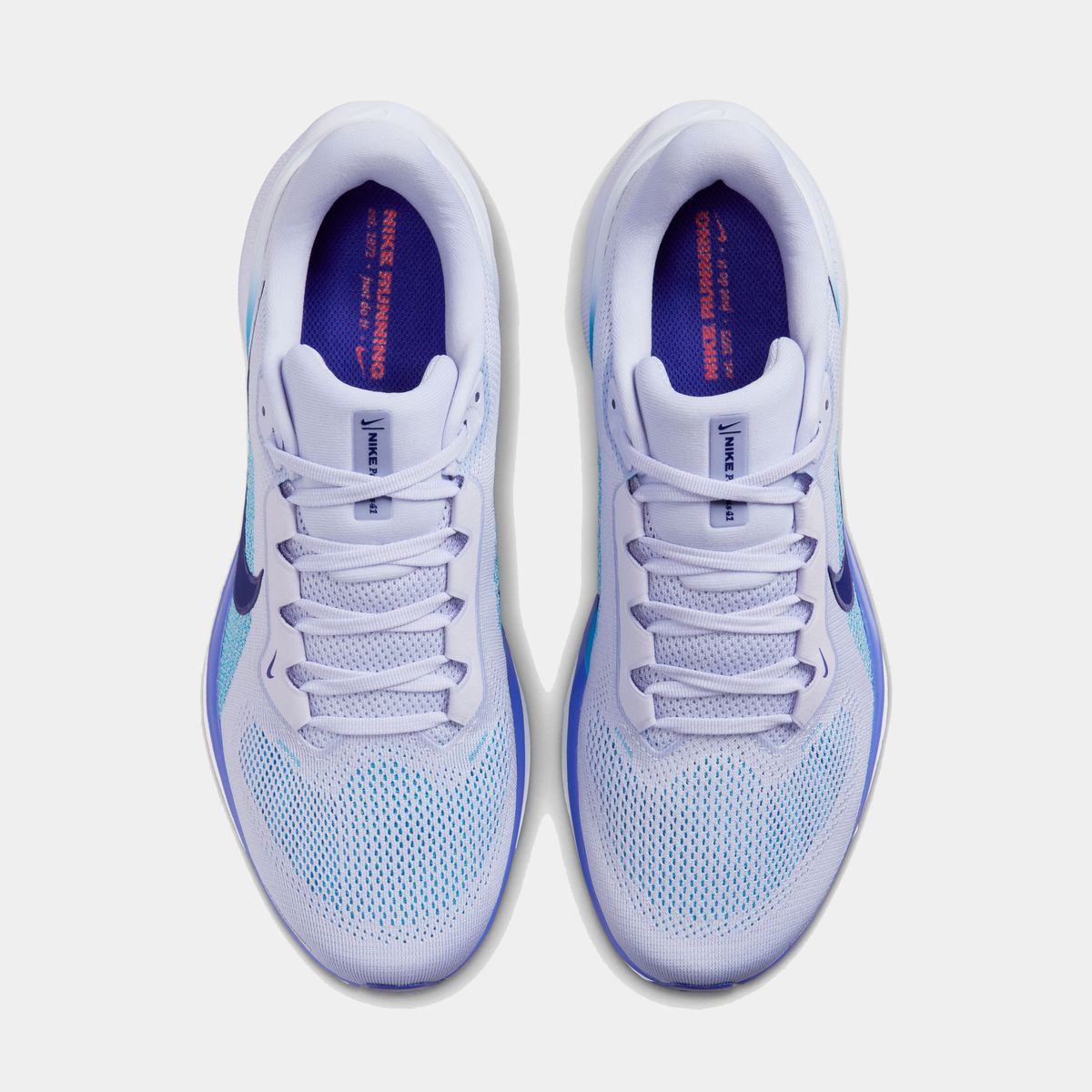 A pair of white Nike Air Zoom Pegasus 41 running shoes with black and blue accents and a black and white sole.