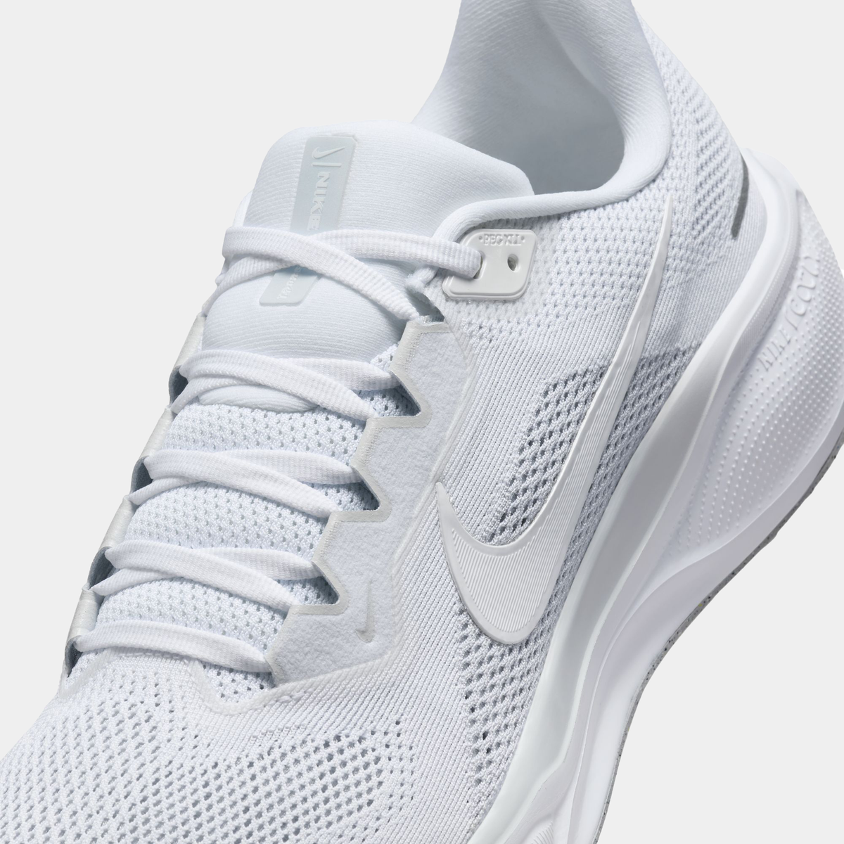 A pair of white Nike Air Zoom Pegasus 41 running shoes with white accents .