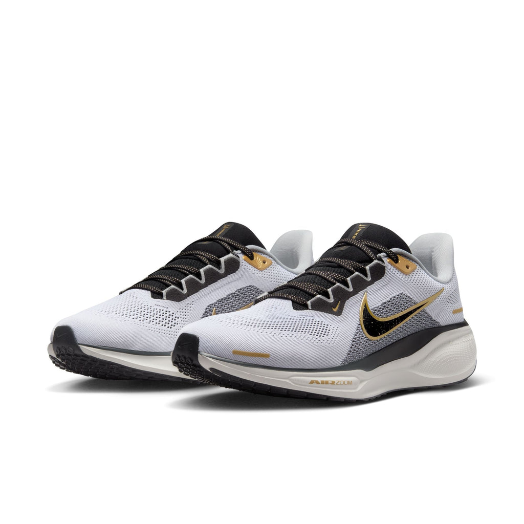 A pair of white and black Nike Air Zoom Pegasus 41 running shoes with black and gold accents and a white and black sole.