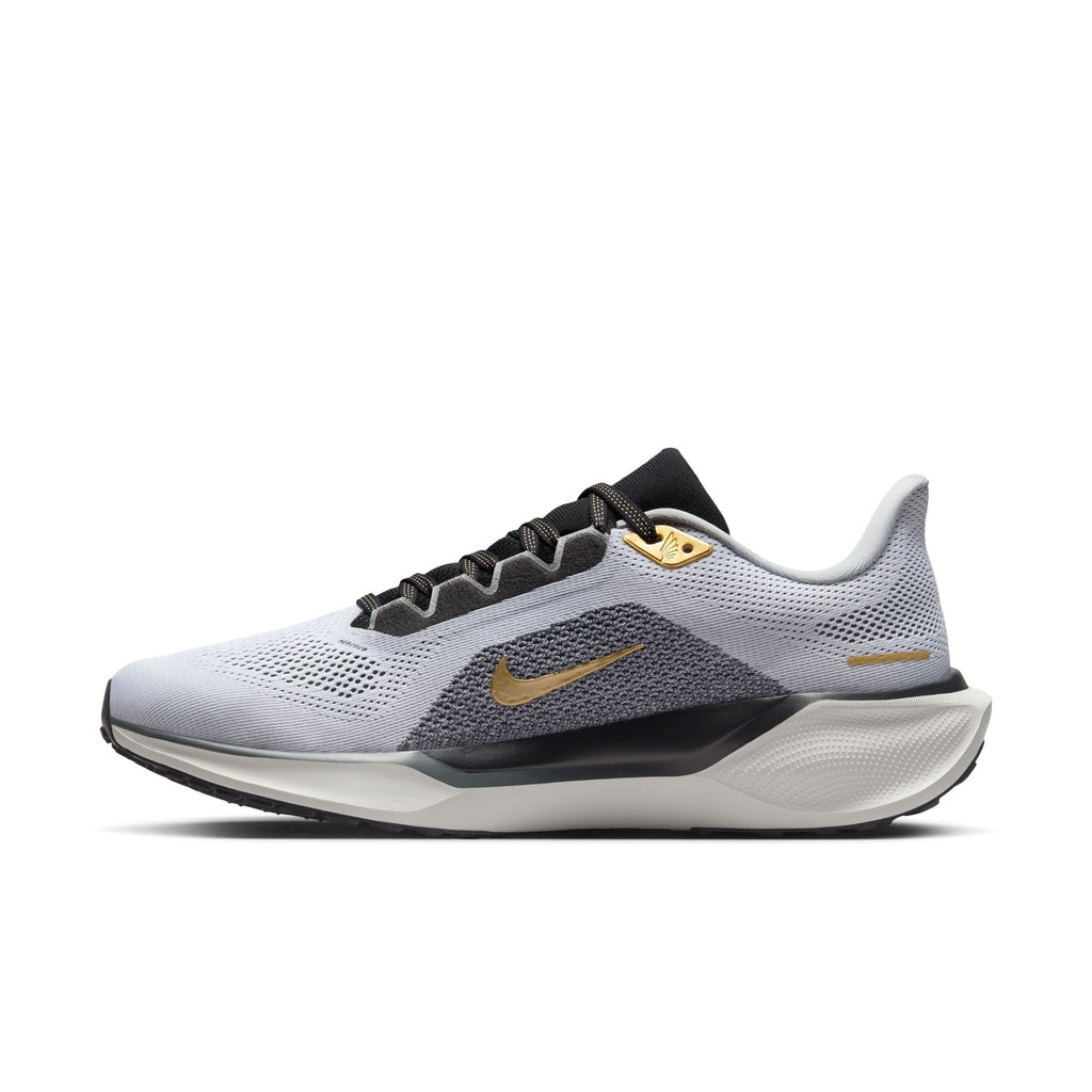 A pair of white and black Nike Air Zoom Pegasus 41 running shoes with black and gold accents and a white and black sole.