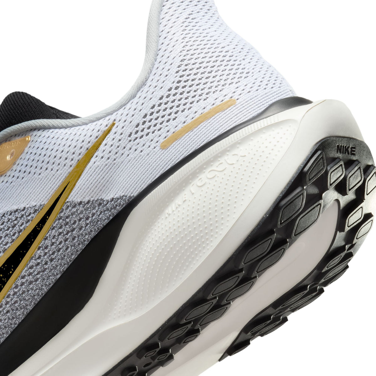 A pair of white and black Nike Air Zoom Pegasus 41 running shoes with black and gold accents and a white and black sole.
