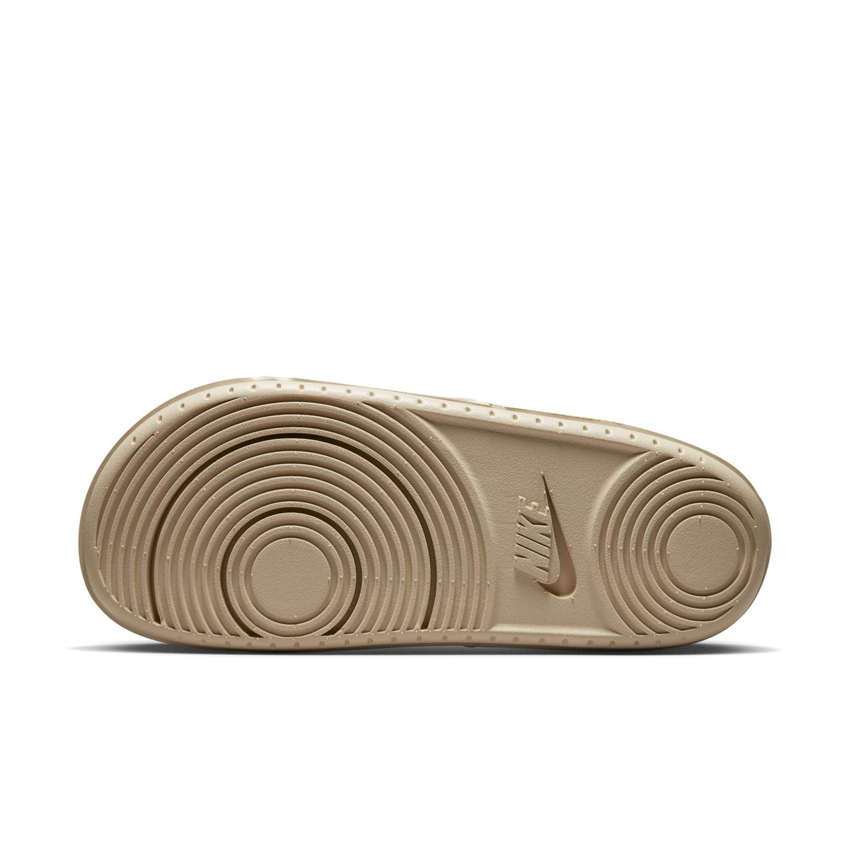 Nike Offcourt Slide footwear outsole in beige showing textured circular tread pattern and Nike logo.