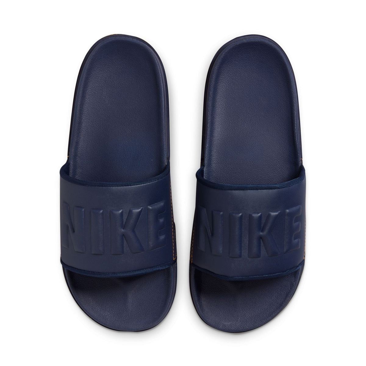 Nike Offcourt Slide sandals in navy blue with textured footbed and embossed Nike logo on wide strap, top view.